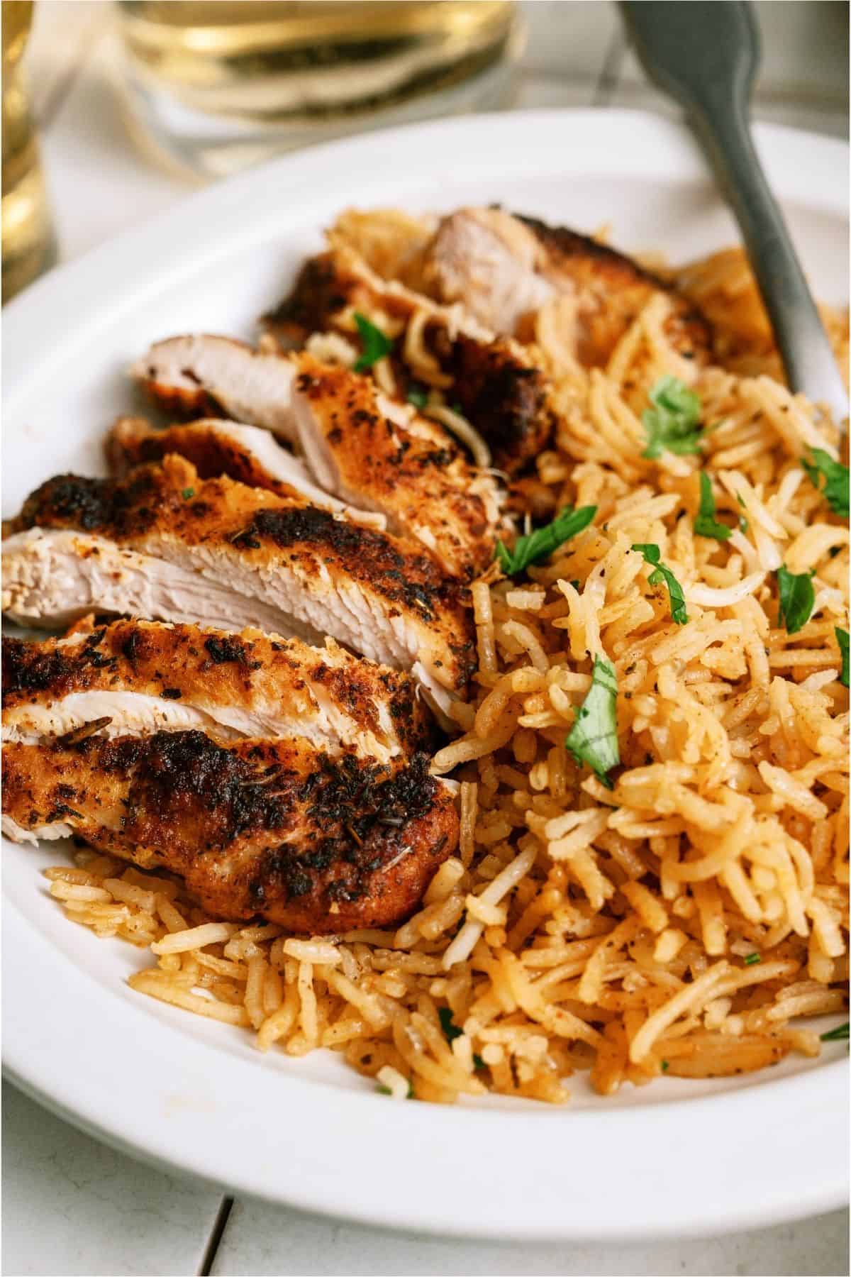 A serving of One Pot Chicken and Rice on a plate with a fork.