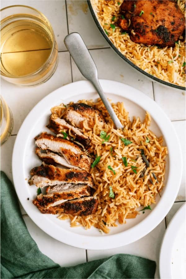 A serving of One Pot Chicken and Rice on a plate with a fork.