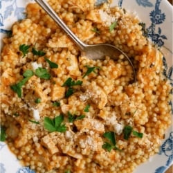 Top view of a bowl of Pastina Soup with a spoon.