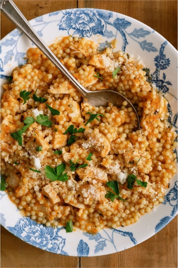 Top view of a bowl of Pastina Soup with a spoon.
