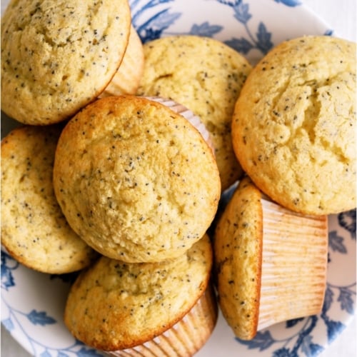 Top view of a plate full of Almond Poppy Seed Muffins.
