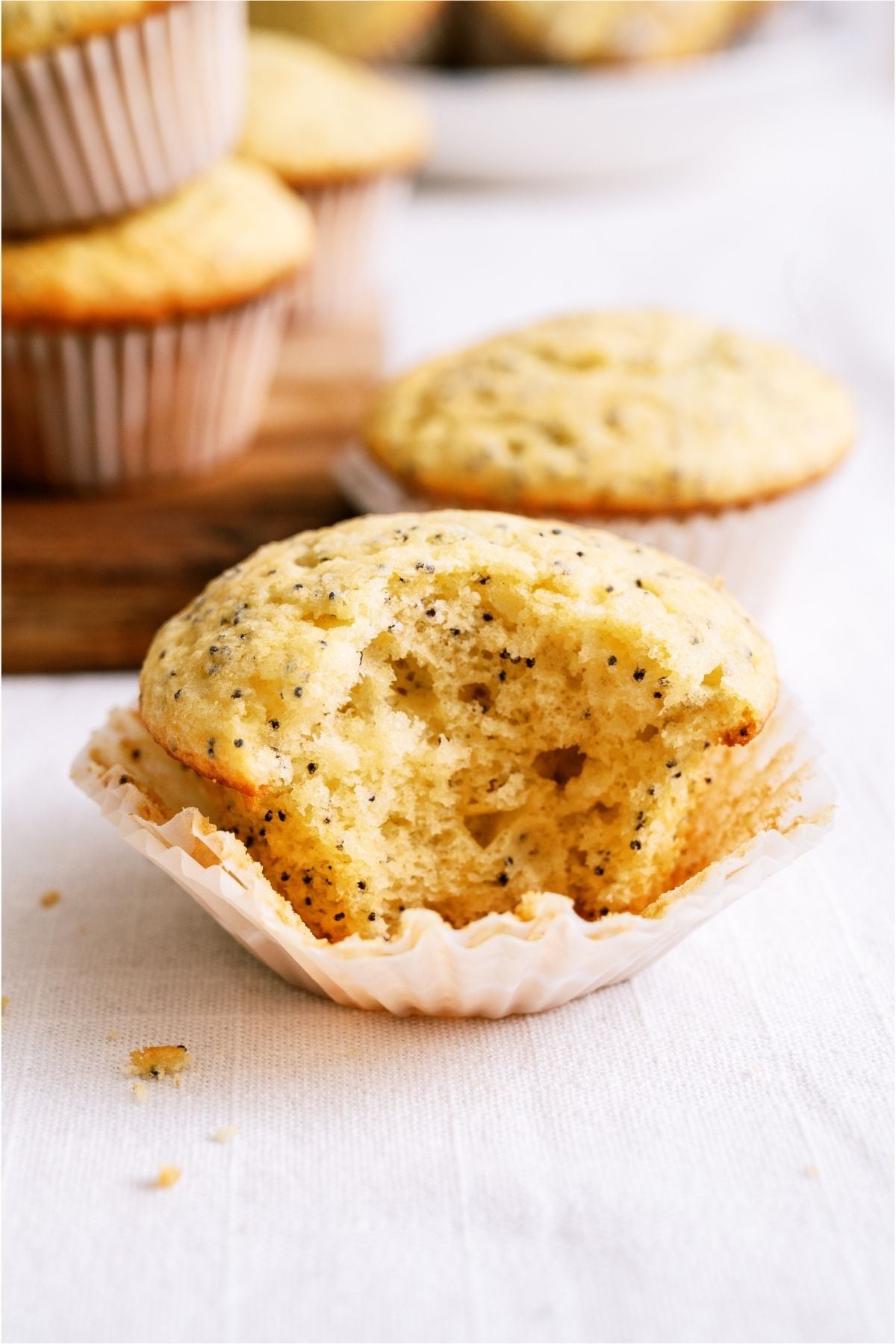 Close up of a Almond Poppy Seed Muffin missing a bite.