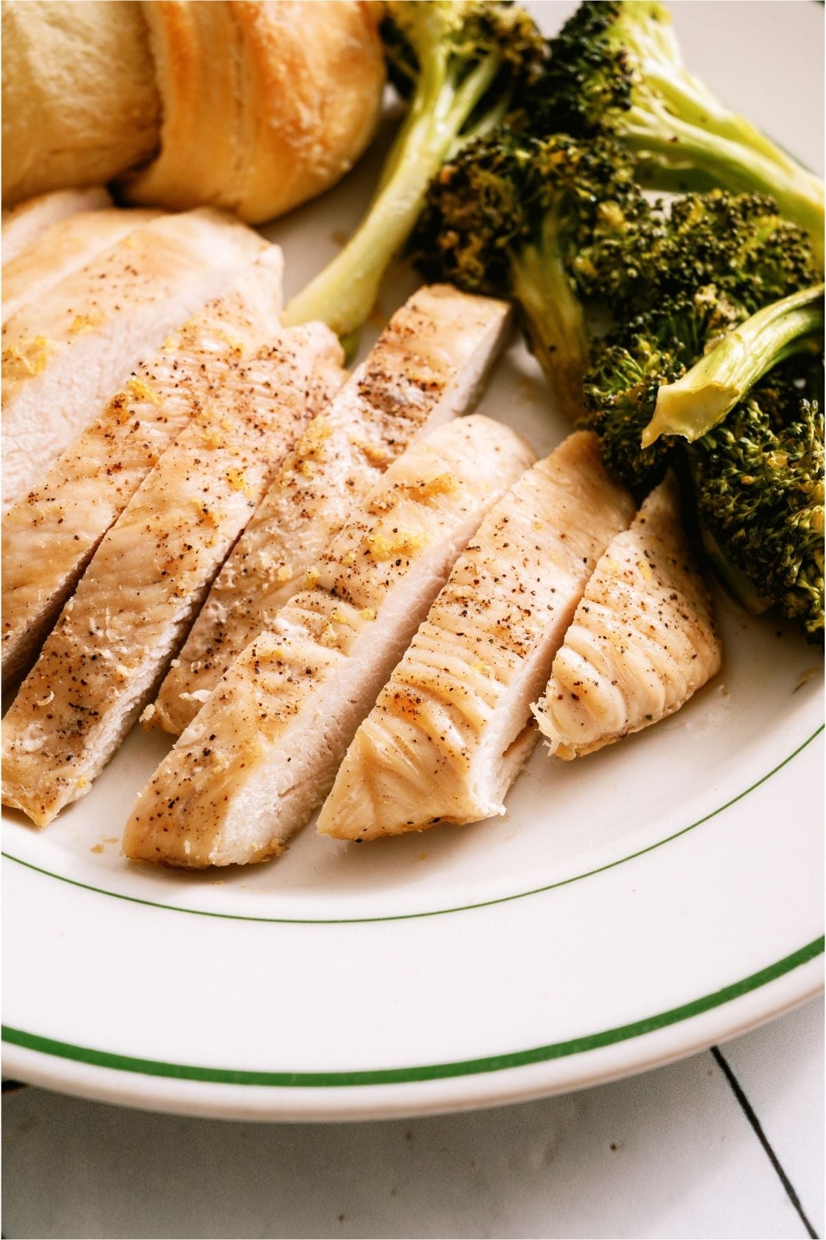 Sheet Pan Honey Lemon Chicken sliced on a plate.