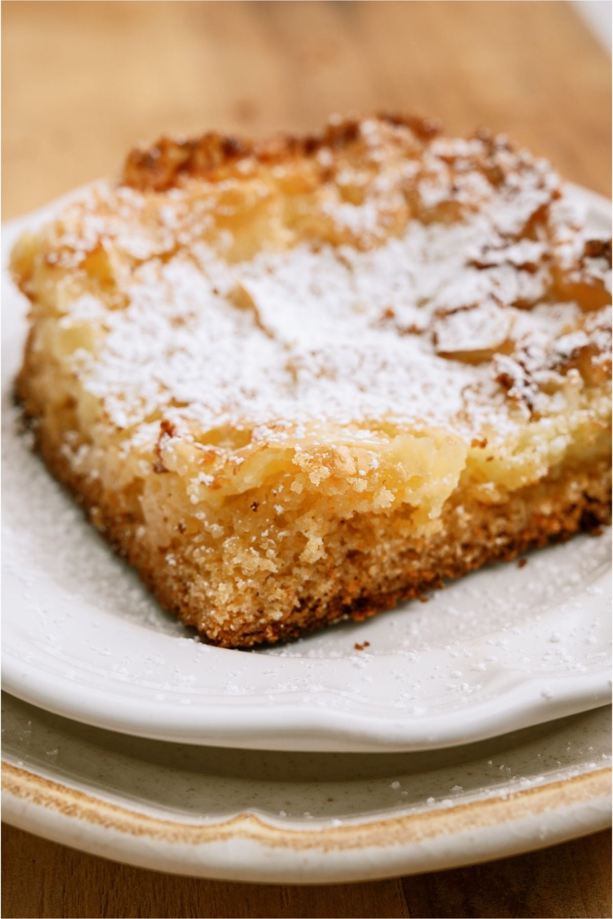 Close up of a slice of Gooey Butter Cake on a plate.