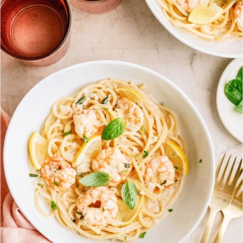 A bowl of Lemon Garlic Shrimp Pasta with a fork on the side.