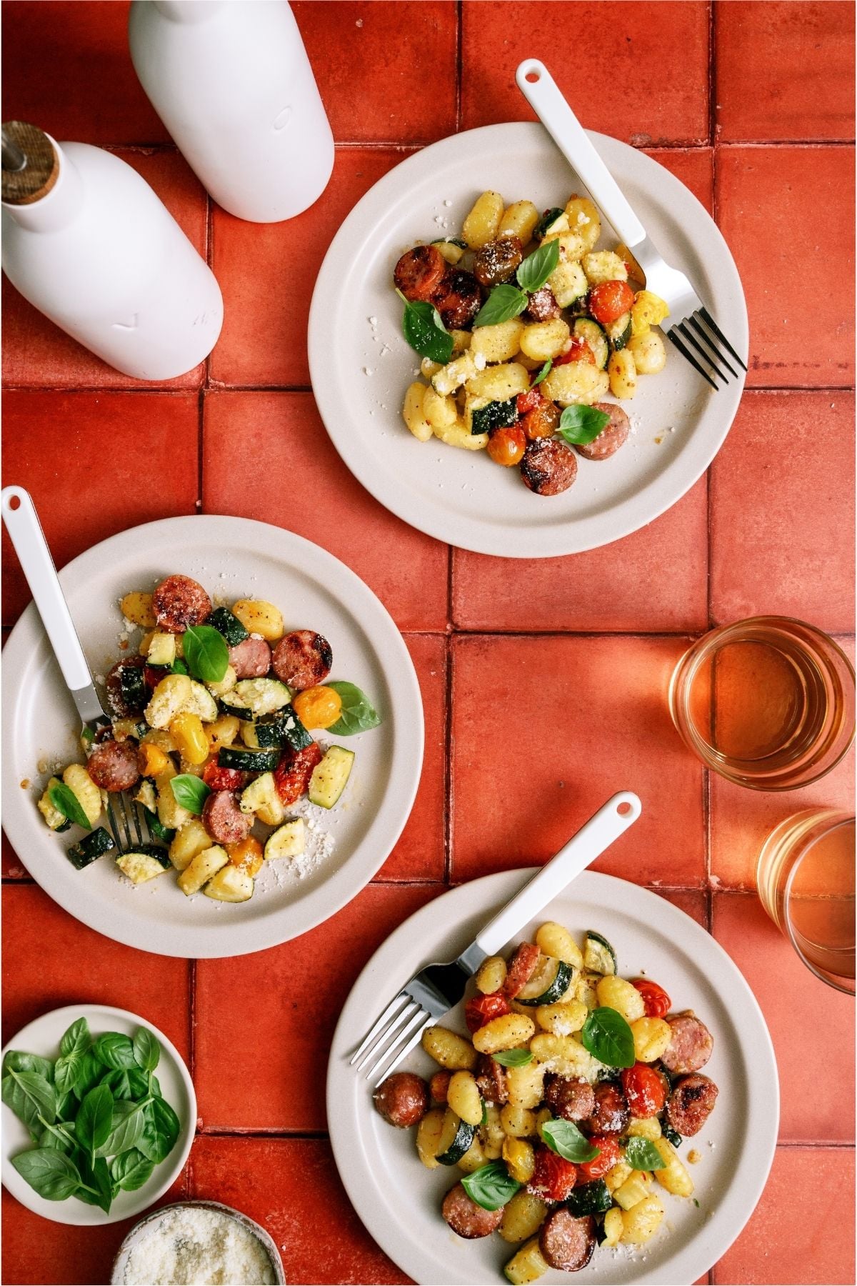 3 plates with servings of Sheet Pan Gnocchi and Chicken Sausage on them.