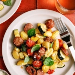 A serving of Sheet Pan Gnocchi and Chicken Sausage on a white plate.