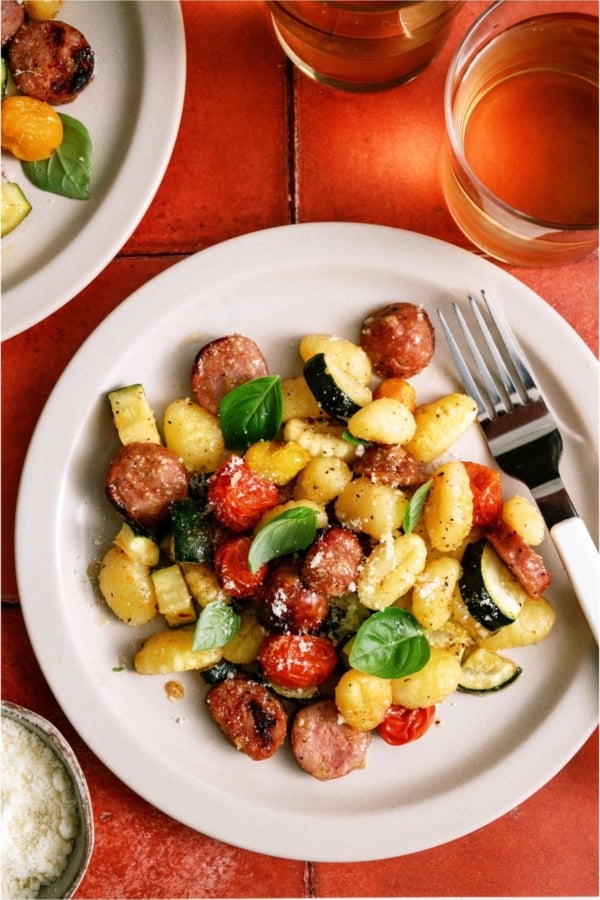 A serving of Sheet Pan Gnocchi and Chicken Sausage on a white plate.