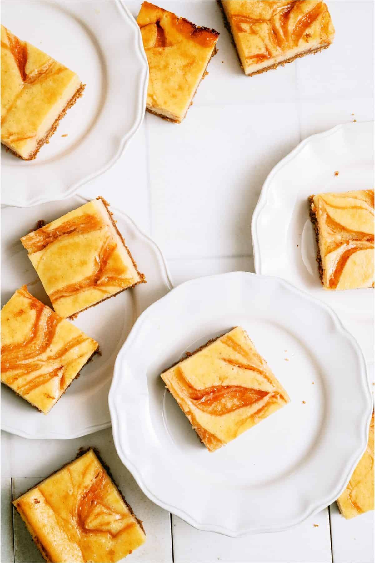 Guava Cheesecake Bars cut into squares and served on plates.