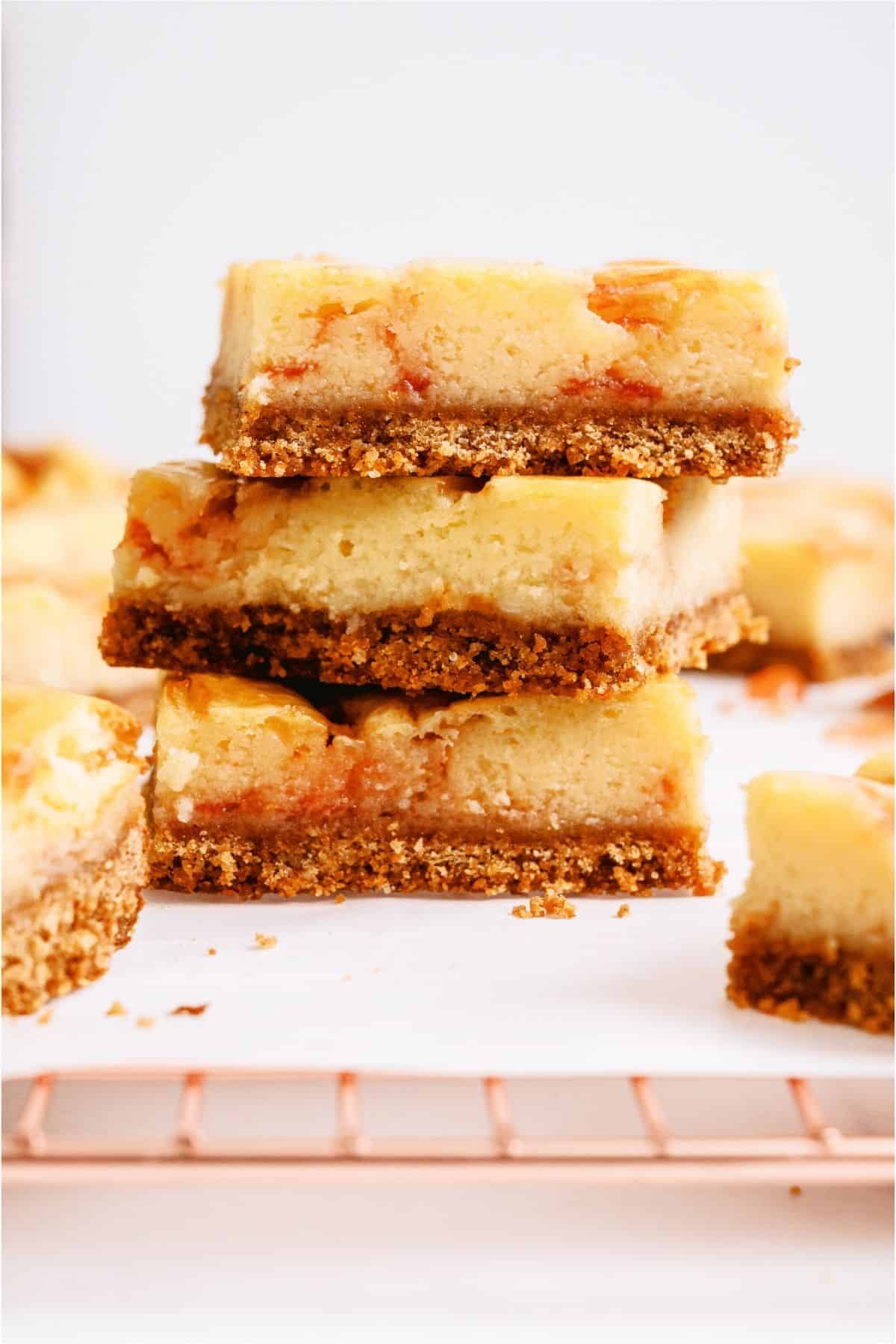 3 Guava Cheesecake Bars stacked on top of each other.