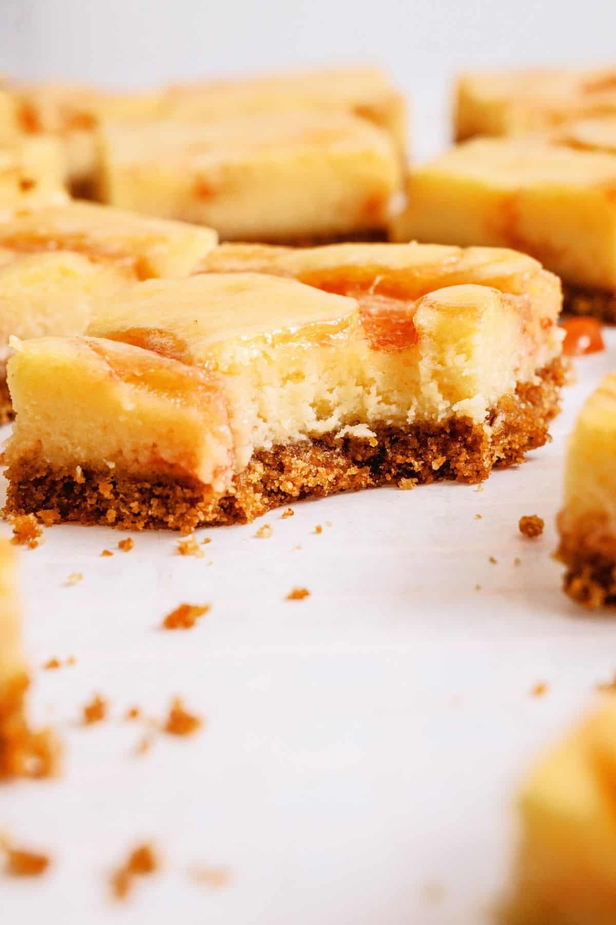 Guava Cheesecake Bars with one missing a bite.
