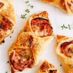 Ham and Swiss Puff Pastries on a white background.