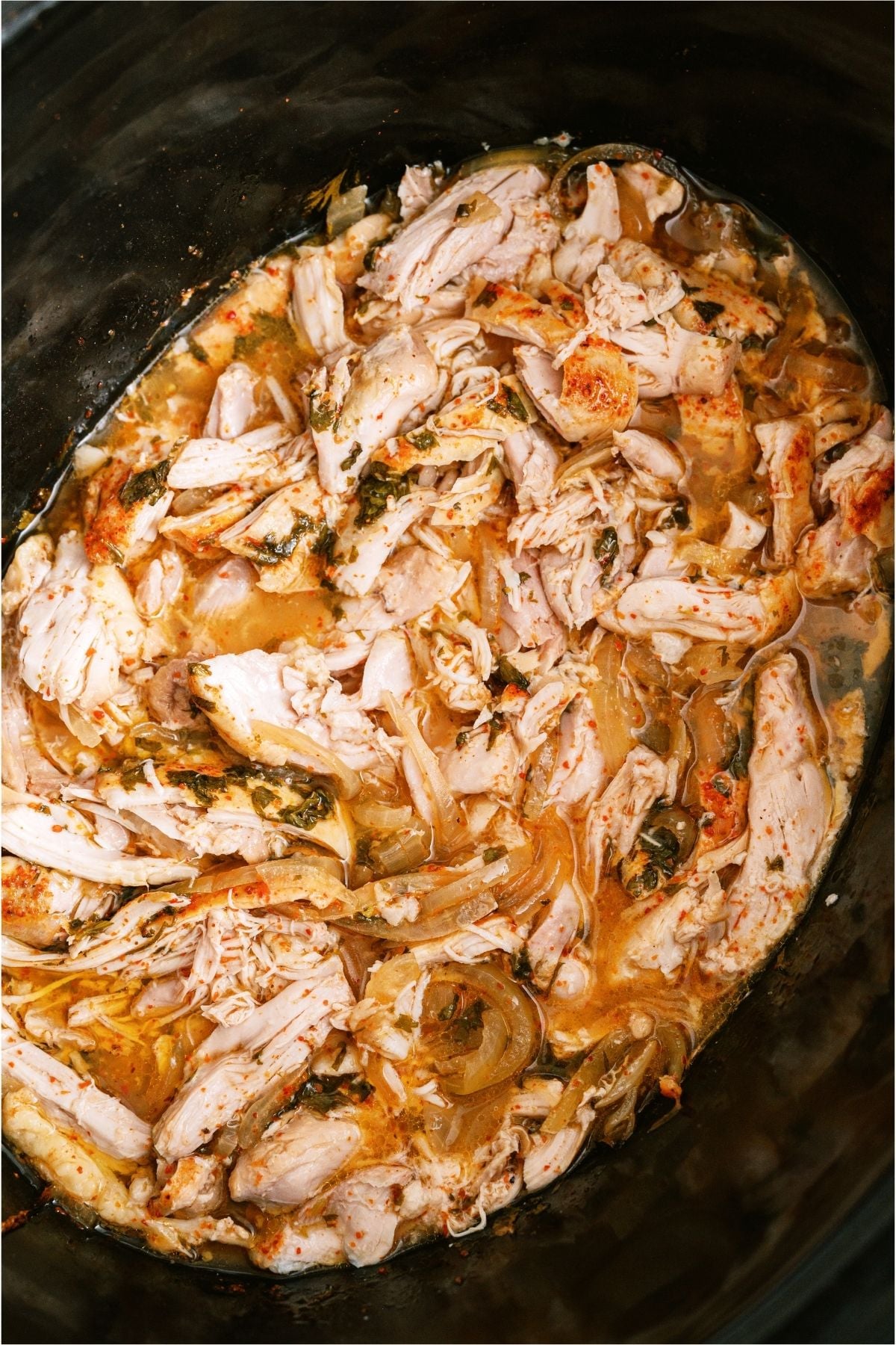 Shredded Slow Cooker Chili Lime Chicken in the slow cooker.