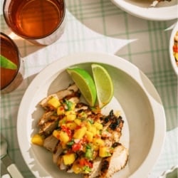 Top view of a plate of Grilled Mango Coconut Chicken sliced.