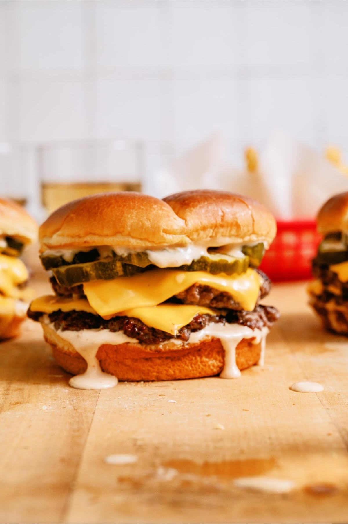 Smash Burger with Shack Sauce on a countertop with other Smash Burgers.