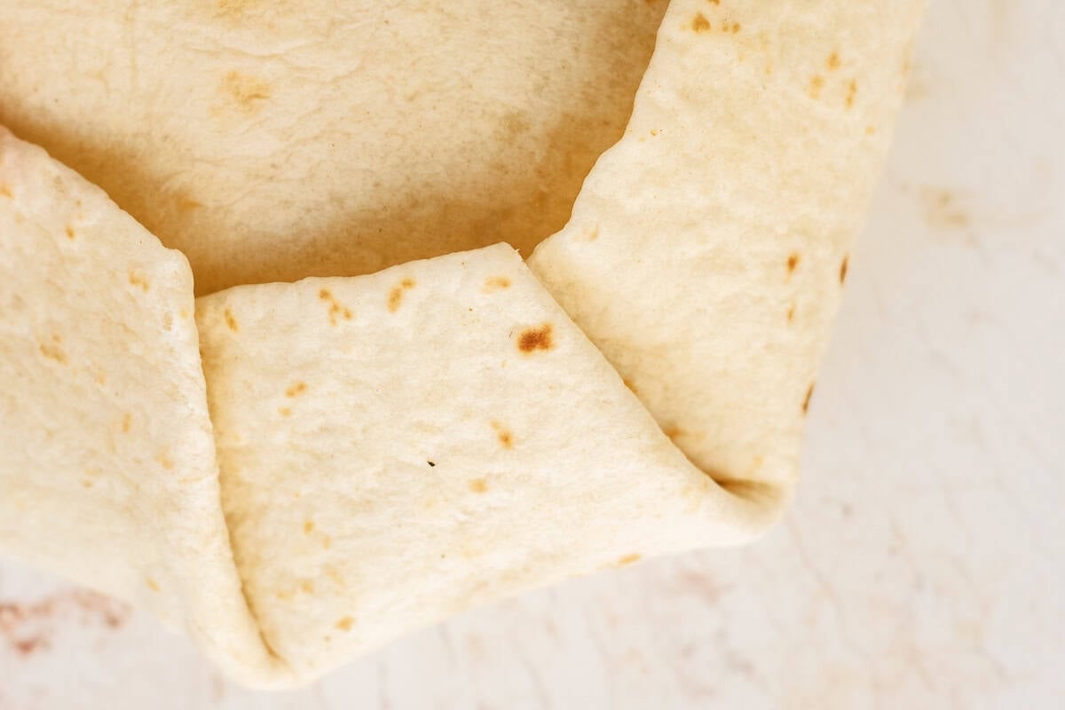 Folded tortilla shell to prevent leakage.