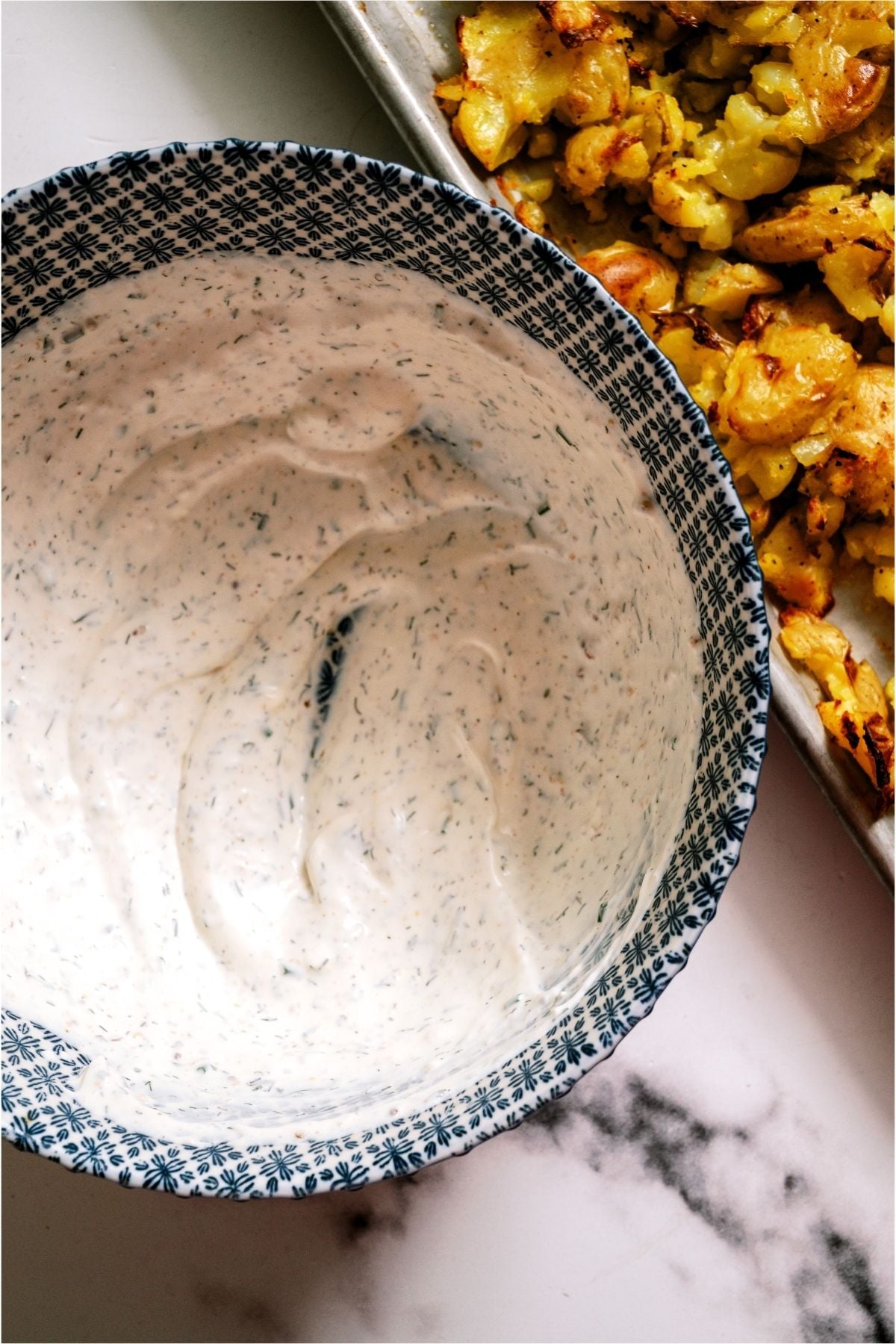 Sauce for Crispy Smashed Potato Salad in a mixing bowl.
