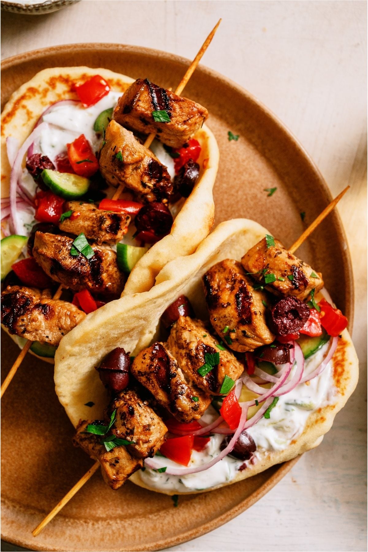 Pork Souvlaki on skewers in a pita.