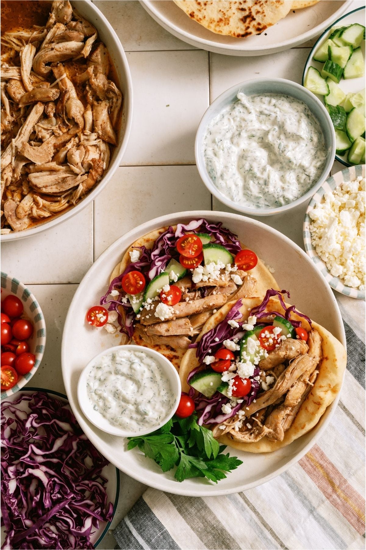 Two pitas with Slow Cooker Chicken Shawarma and toppings.