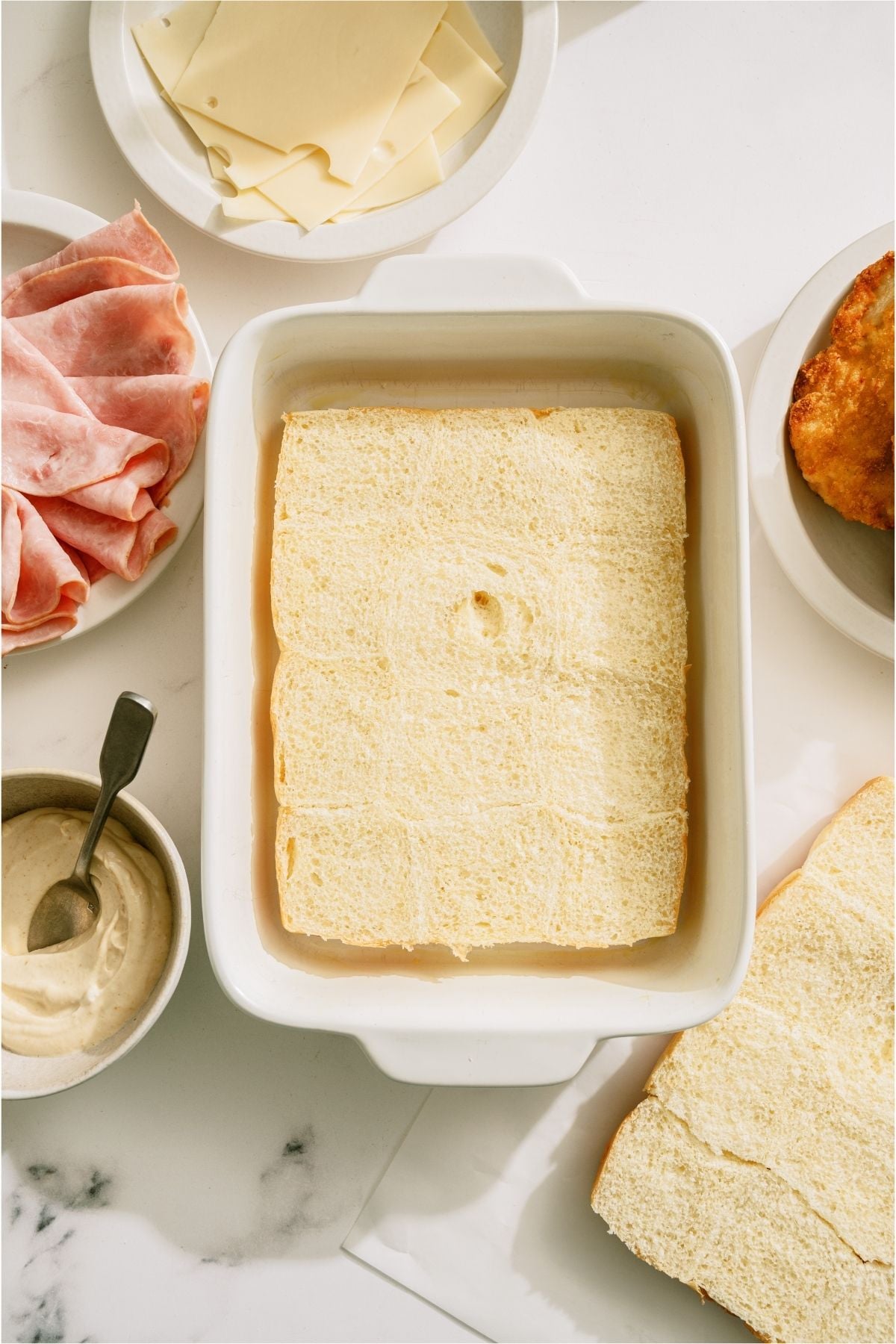 Bottom half of rolls in a baking dish.