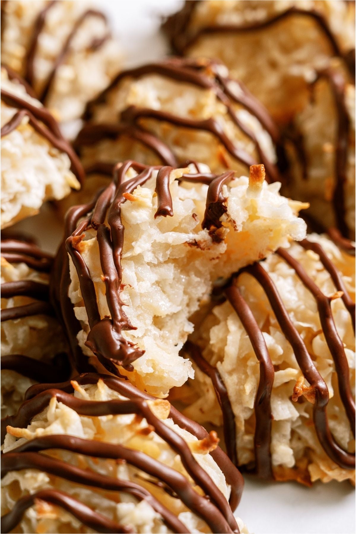 Easy Coconut Macaroons with one on top that is missing a bite.