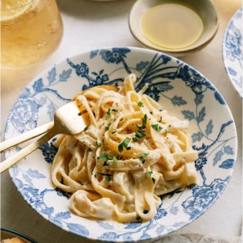 Top view of a plate of No Fail Fettuccine Alfredo with forks.
