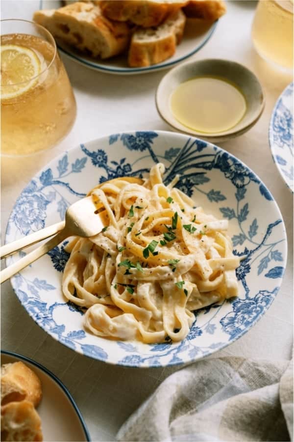 Top view of a plate of No Fail Fettuccine Alfredo with forks.