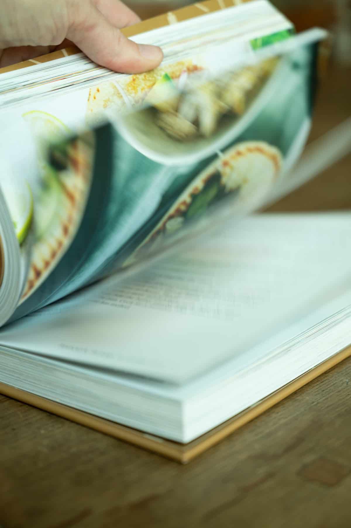 Open cookbook with colorful food images and recipes for family meals.