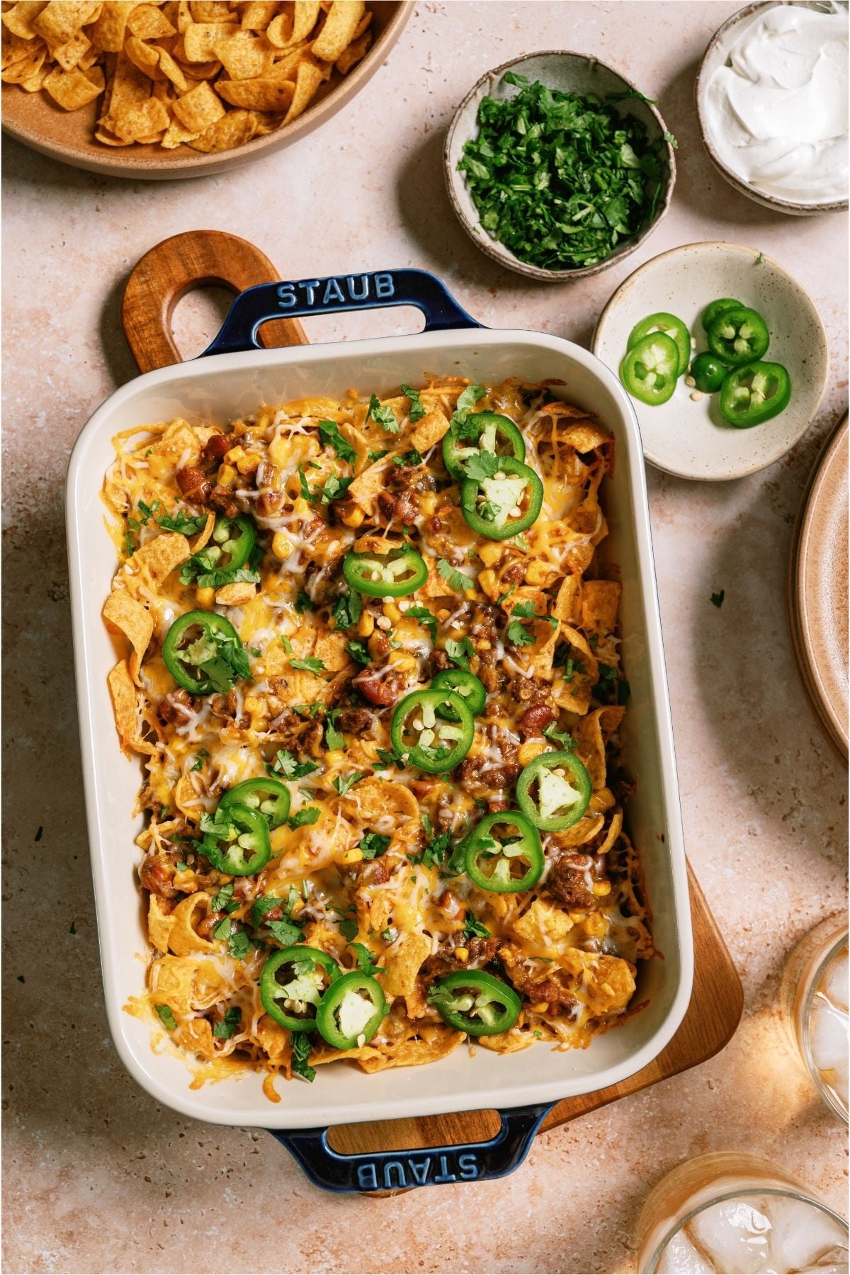 Top view of Frito Pie in a casserole dish topped with peppers.