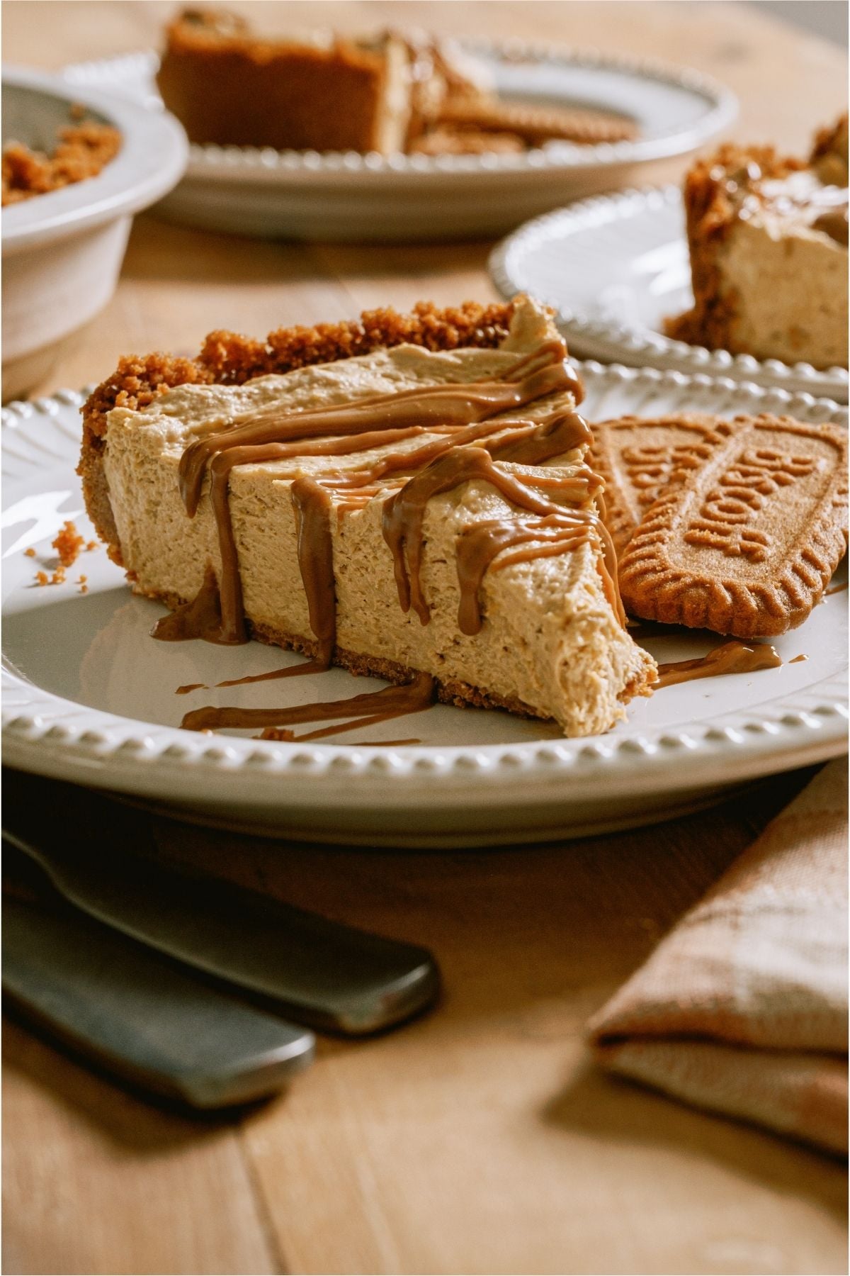 Front view of a slice of No Bake Biscoff Cheesecake on a plate.