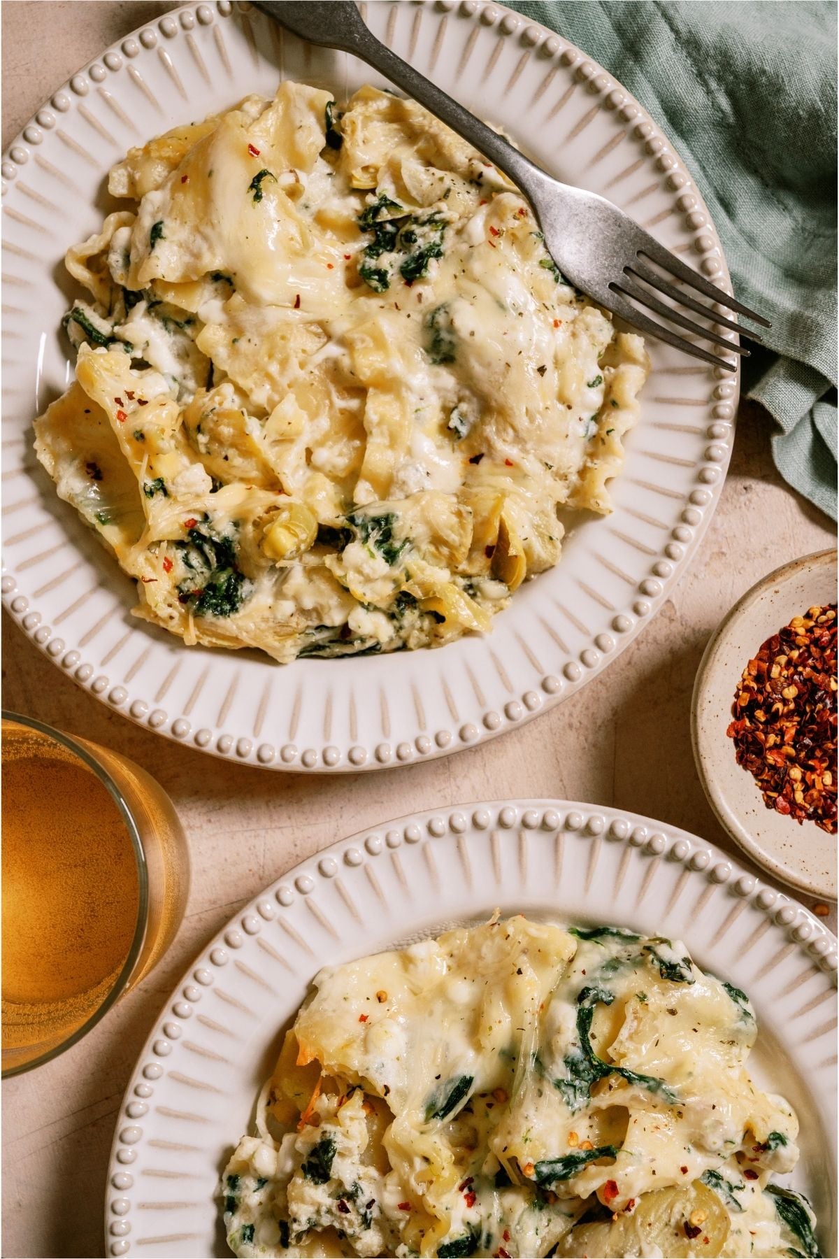 Two plates with servings of Sheet Pan Lasagna.