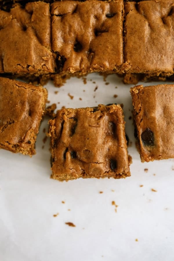 Close-up of chocolate chip cookie bars with one piece cut out.